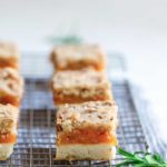 Side angle of rosemary apricot bars, highlighting filling