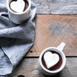 A photo of Hot Chocolate topped with Whipped Cream Melting Heart