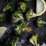 A close up of roasted broccoli with garlic and lemon