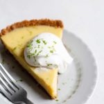 A slice of key lime pie topped with whipped cream