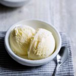 Two scoops of lemon ice cream in a bowl