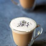 London Fog drink (tea latte) in a clear mug, topped with dried lavender