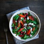 Cranberry orange salad recipe in a salad bowl with a fork and napkin
