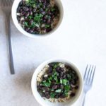 Black beans and rice recipe in a bowl next to a fork.