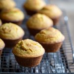 Homemade corn muffins on a cooling rack